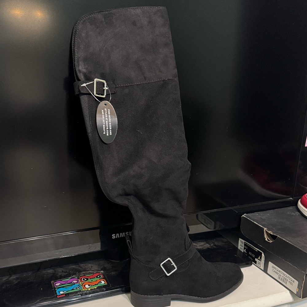 Sun + Stone black over the knee boots.